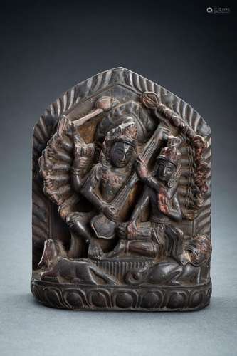 A RARE NEPALESE STONE STELE OF VEENADHARA SHIVA AND UMA