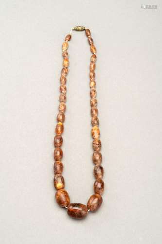 A HIMALAYAN NECKLACE WITH THIRTY-FOUR AMBER BEADS
