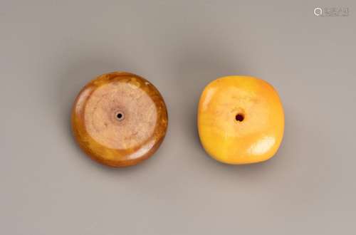 TWO HIMALAYAN BEADS IN IMITATION OF AMBER
