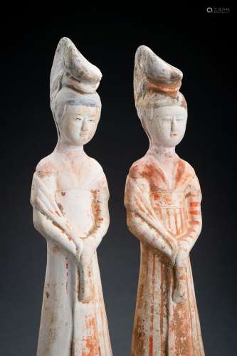 A PAIR OF PAINTED TANG DYNASTY POTTERY COURT LADIES