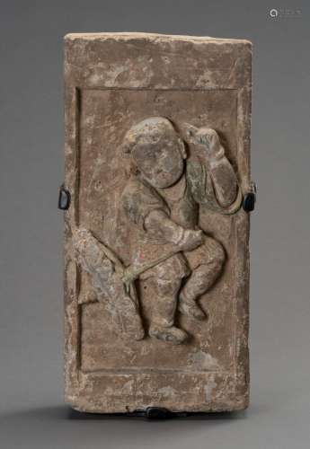 A TERRACOTTA WALL BRICK DEPICTING A CHILD WITH UMBRELLA, SON...