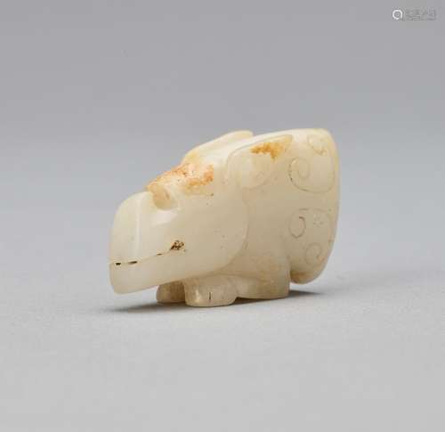 AN ARCHAISTIC WHITE JADE MYTHICAL BEAST HEAD, QING