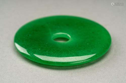 A TRANSLUSCENT GLASS ‘IMITATION JADEITE’ BI DISC