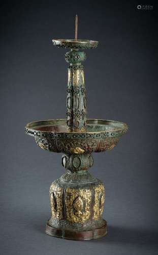 A LARGE ARCHAISTIC PARCEL GILT COPPER REPOUSSÉ CANDLESTICK