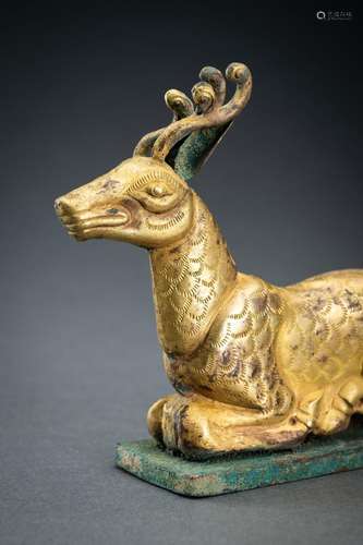 AN ARCHAISTIC FIRE-GILT COPPER REPOUSSÉ FIGURE OF A DEER