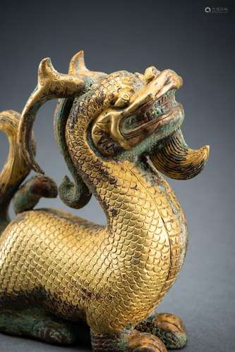 AN ARCHAISTIC FIRE-GILT COPPER REPOUSSÉ FIGURE OF A DRAGON