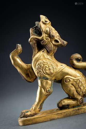 AN ARCHAISTIC FIRE-GILT COPPER REPOUSSÉ FIGURE OF A DRAGON