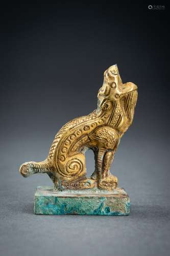 AN ARCHAISTIC FIRE-GILT COPPER REPOUSSÉ FIGURE OF A MYTHICAL...