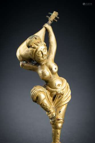 AN ARCHAISTIC FIRE-GILT COPPER REPOUSSÉ FIGURE OF A SEMI-NUD...