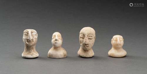 A LOT WITH FOUR BACTRIAN WHITE MARBLE AND STONE IDOL HEADS