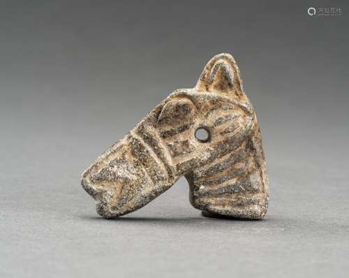 A SMALL CHLORIDE STONE AMULET OF A HORSE HEAD