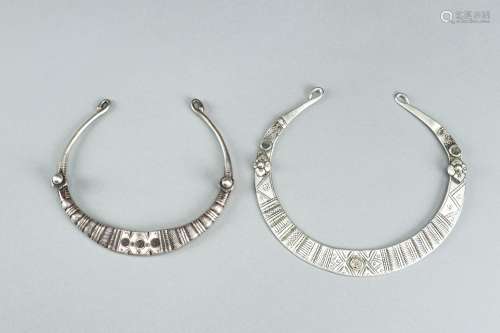 A PAIR OF ENGRAVED TRIBAL SILVER AND METAL TORQUES, c. 1900s