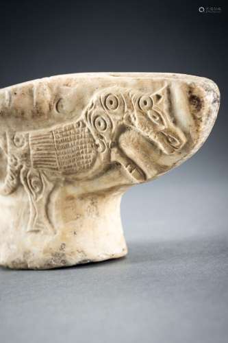 A GHAZNAVID CARVED ALABASTER OIL LAMP WITH WINGED BEASTS
