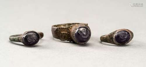 THREE PERSIAN BRONZE RINGS WITH AMETHYST INTAGLIOS