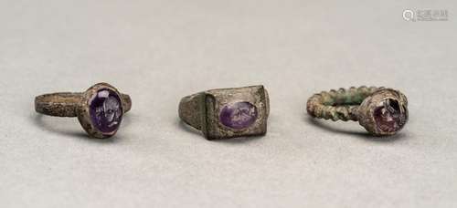 THREE PERSIAN BRONZE RINGS WITH AMETHYST INTAGLIOS