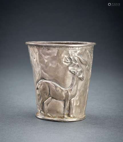 A PERSIAN SILVER REPOUSSÉ ‘ANTELOPE’ BEAKER