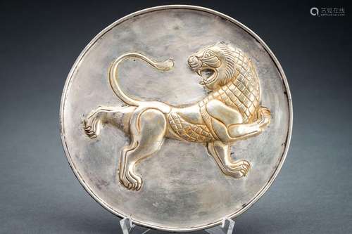 A PERSIAN PARCEL-GILT SILVER REPOUSSÉ ‘LION’ DISH