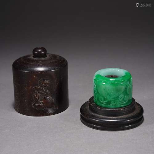 A JADEITE CARVED FLOWER ARCHERS RING