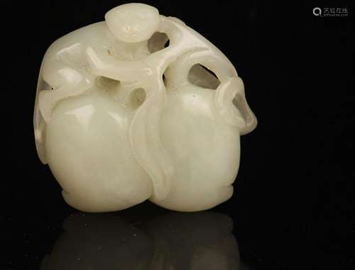 A FINE PALE CELADON JADE IN FIGURE OF MONEY