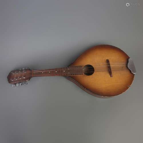 AN OLD WOODEN GUITAR