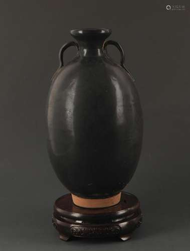 A BLACK GLAZED TWO TILE JAR