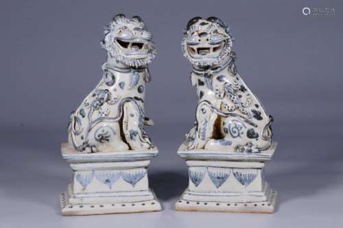 A pair of blue and white lion ornaments on the shore