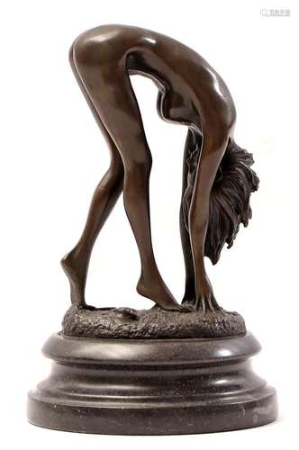 Bronze sculpture of a bent nude