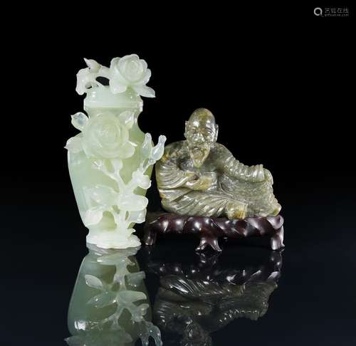 A Chinese green jade figure of a seated man