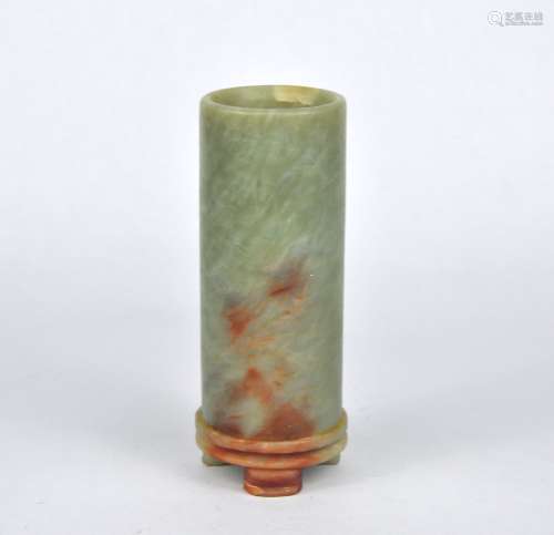 A Chinese celadon tubular stone vase on a fitted stand