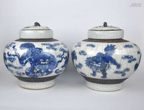 A pair of Chinese crackle glazed covered jars, painted with ...