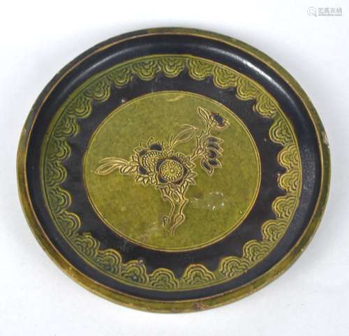 A Chinese green & brown glazed dish carved with flower, Qing...