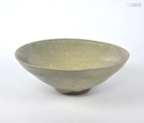 An early Chinese celadon bowl with molded flower, Song dynas...