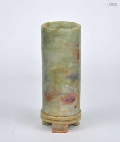 A Chinese celadon tubular stone vase on a fitted stand