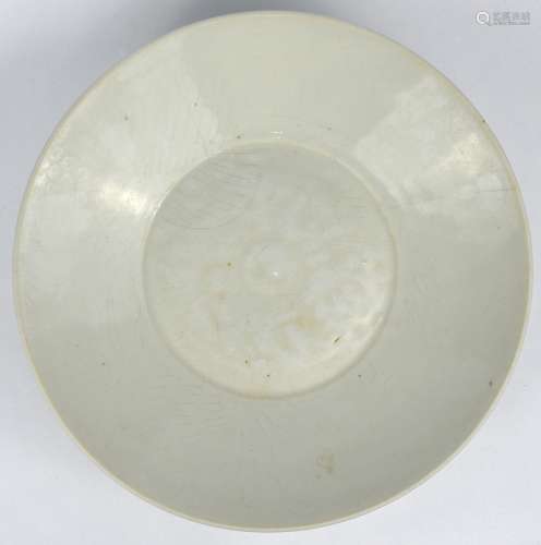 A large Chinese white glazed charger carved with fish & flow...