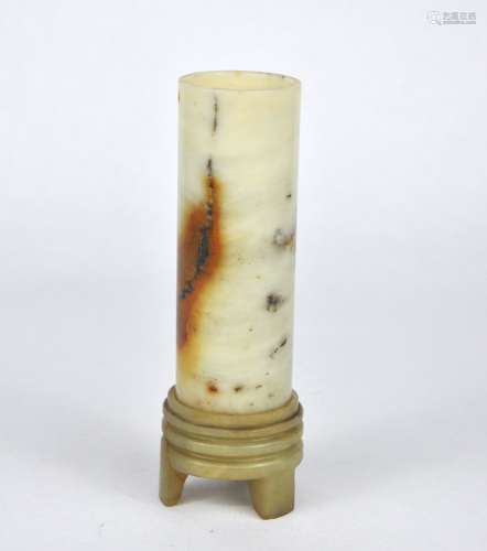 A Chinese white & russet tubular stone vase on a fitted stan...