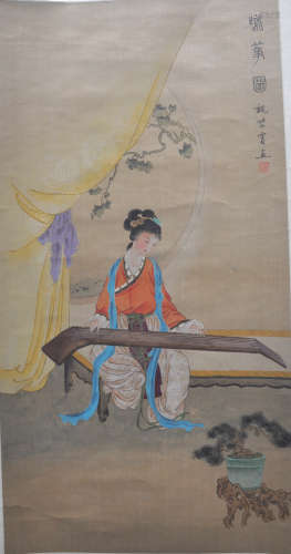 A Chinese painting scroll of a lady playing Guqing,