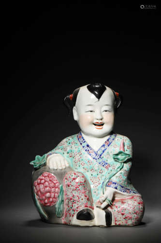 A FAMILLE ROSE LOTUS-HOLD BOY ORNAMENT, YOU LIN JI ZAO