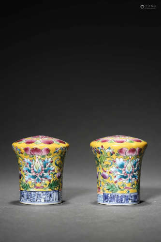 A PAIR OF YELLOW GROUND FAMILLE ROSE FLOWER FINIALS FOR PAIN...