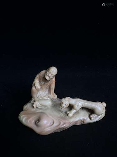 A seated statue of an arhat in jade