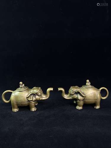 A pair of copper like teapots