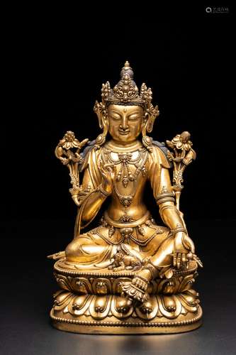 A LARGE GILT BRONZE SEATED AVALOKITESVARA OF THE MING DYNAST...