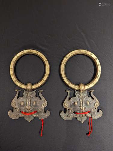 A PAIR OF BRONZE DOOR HANDLE