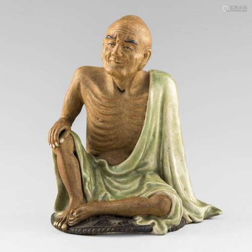 A Chinese Shiwan figure of a luohan, signed Wen Zhongling, 1...