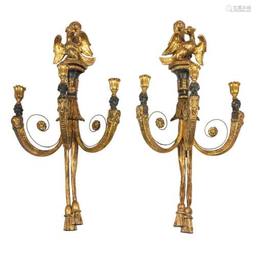 A pair of French Neoclassical parcel ebonized and giltwood t...