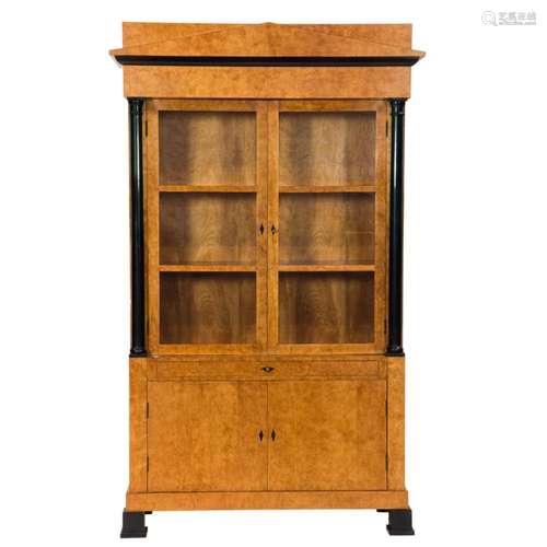 A large Biedermeier style fruitwood vitrine, the outset top ...