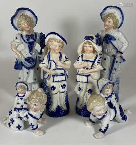 A GROUP OF SIX CONTINENTAL BLUE AND WHITE PORCELAIN FIGURES,...