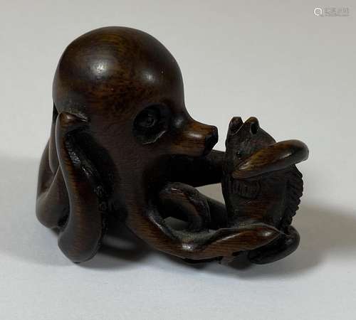 AN ORIENTAL NETSUKE OF AN OCTUPUS AND FISH, SIGNED WITH MOTH...