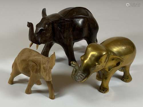 A GROUP OF THREE ELEPHANT FIGURES TO INCLUDE TWO CARVED WOOD...