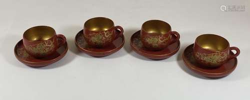 A SET OF FOUR ORIENTAL RED AND GILT LACQUERED CUPS AND SAUCE...