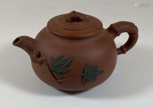 A CHINESE YIXING CLAY TEAPOT WITH FLORAL RELIEF MOULDED DESI...